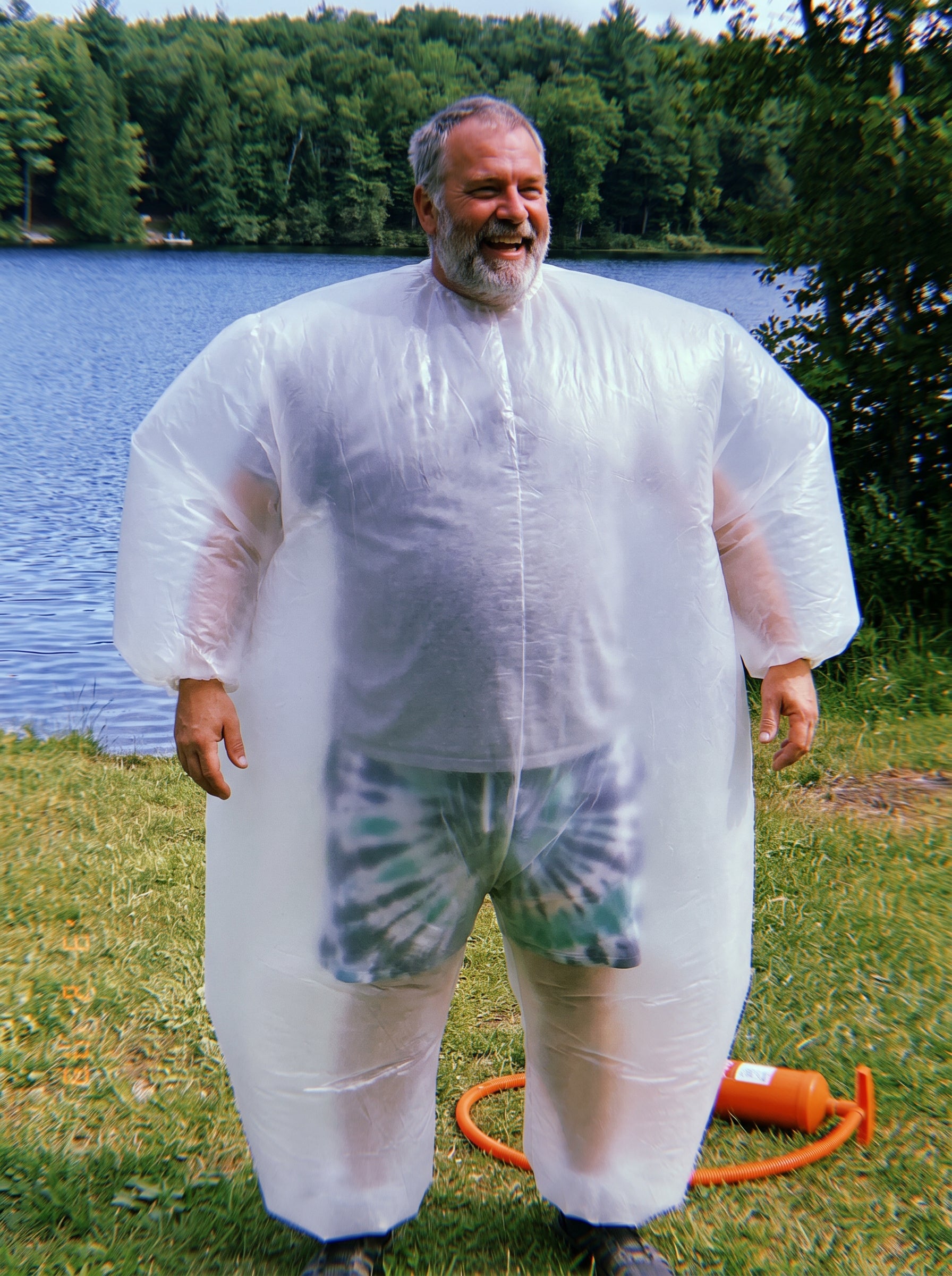 Man wearing the Float Bro Suit standing at the lake